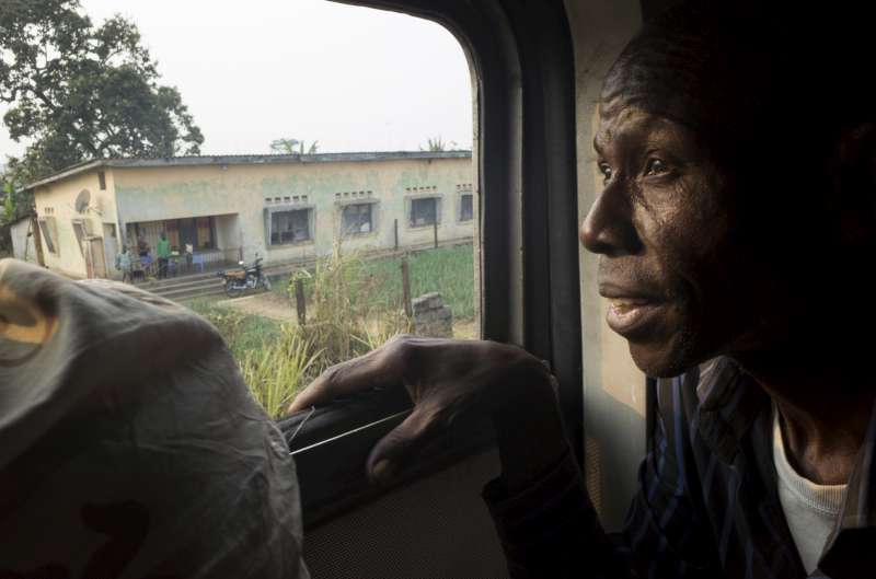 Antonio stares out of the carriage window as the train heads westwards on the 220-kilometre journey to Kimpese, where they will board buses for the journey to the border.