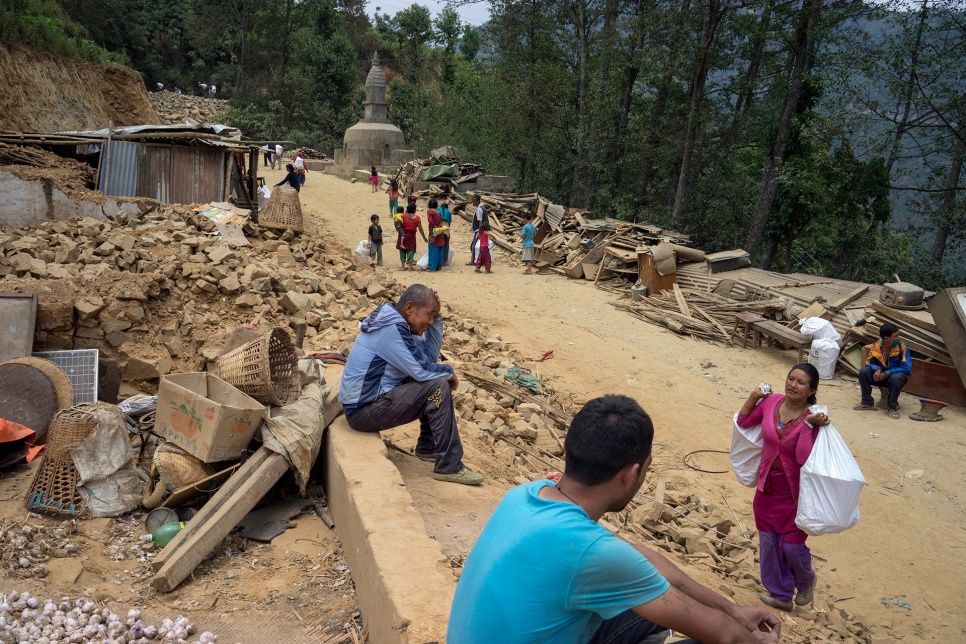 Dhan Bahadur Tamang, 66, sits in the rubble of his family's home along a roadside in the village of Jhankridanda, Lalitpur District, Nepal.