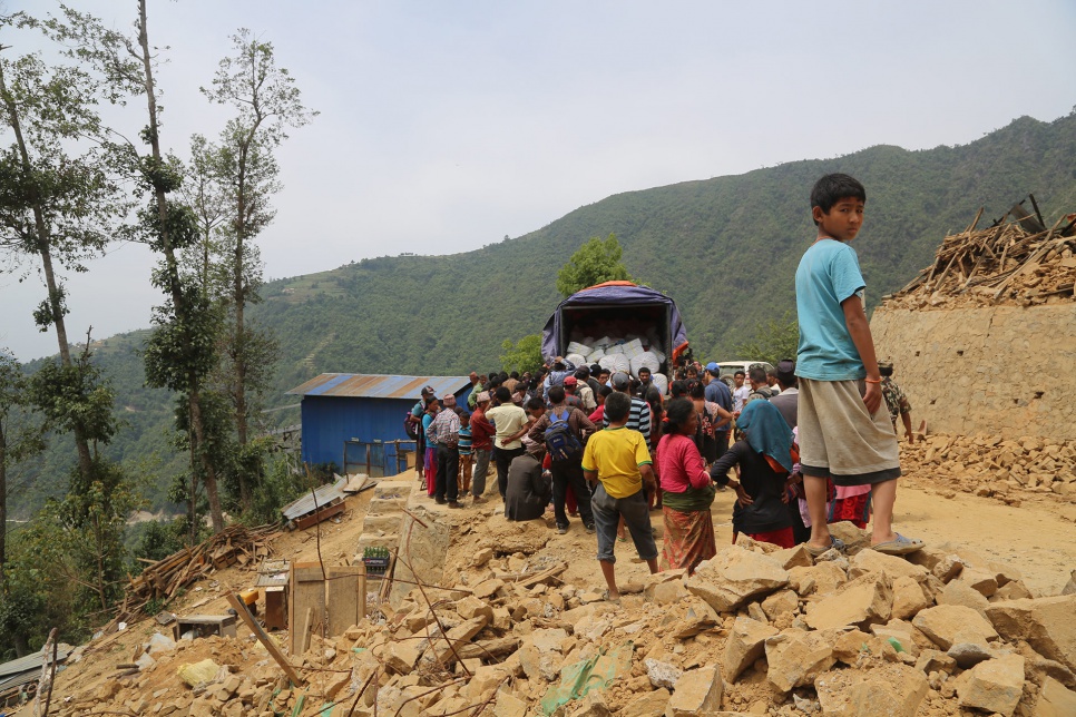 Survivors of the April earthquake collect UNHCR tarps, buckets, soap, towels and toothbrushes in Jhankridanda village, in Lalitpur District, Nepal.