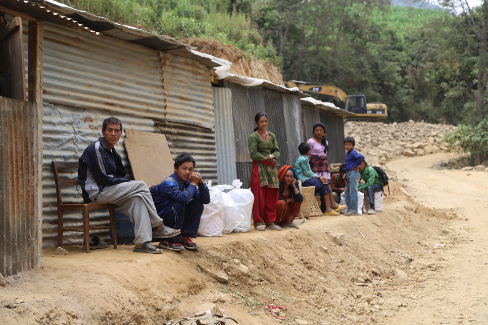 Dhan Bahadur Tamang's family now live in the corrugated iron shack on the far left, sharing a section of the narrow dirt road with two other families in Jhankridanda village.