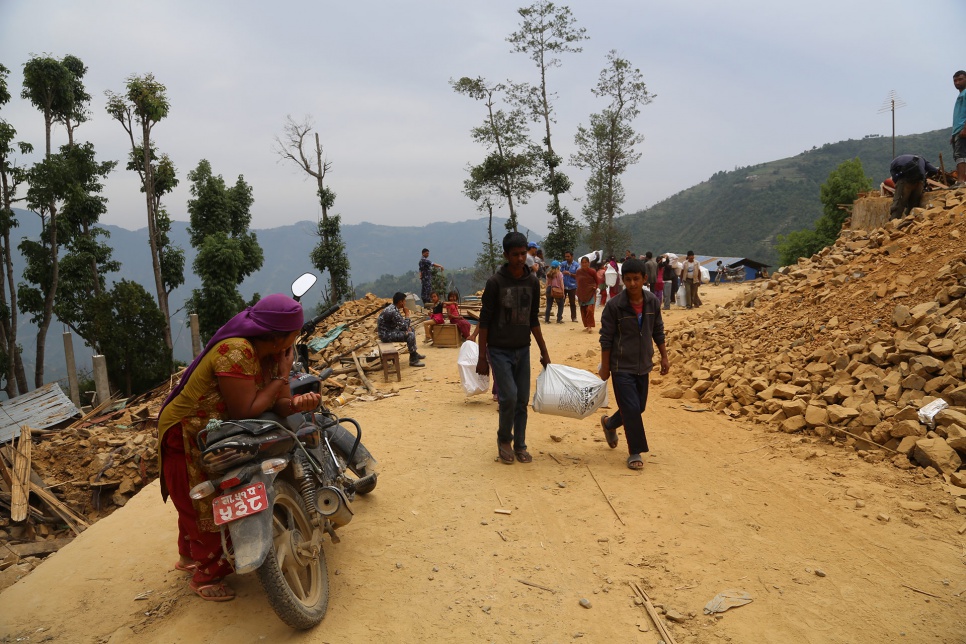 Two young Nepalis carry relief items back to the place where they have been sheltering since the devastating earthquake rocked Nepal on 25 April.