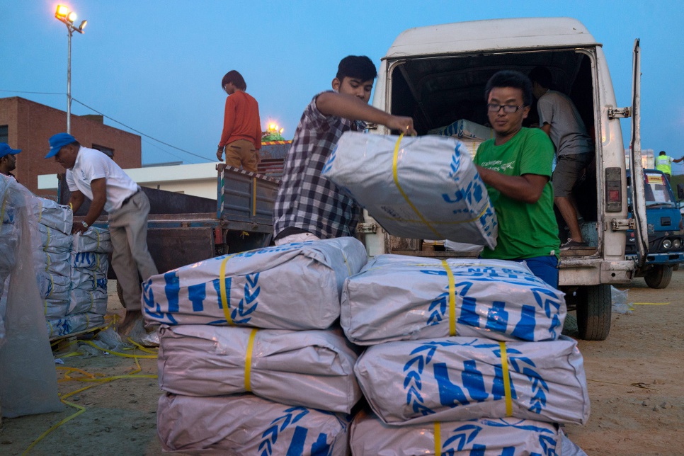 At the airport in Kathmandu, local volunteers unload UNHCR relief supplies before they are distributed to communities affected by the April earthquake.