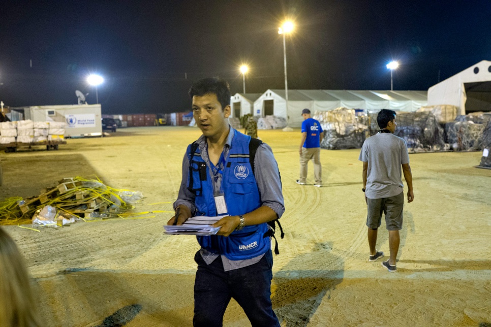 Deepesh Shrestha, a UNHCR communications officer, works into the night at Tribhuvan International Airport in Kathmandu, Nepal.