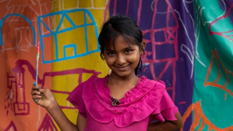Bangladesh. A child painting a UNHCR tent