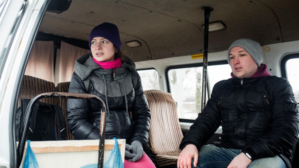 Yulia and Sasha wait on a minibus near the Mariinka checkpoint.