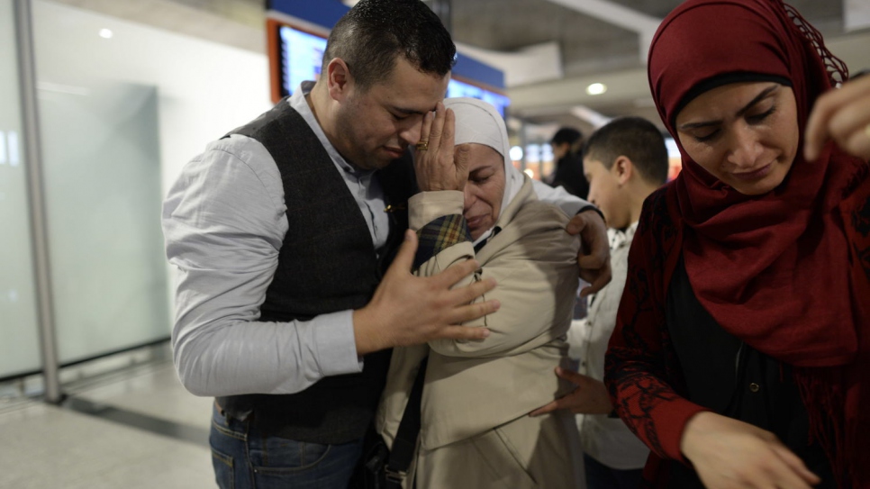 Syrian refugee and former TV chef Mohammad El Khaldy, 36, greets his mother for the first time in four years in the arrivals lounge at Charles De Gaulle Airport.