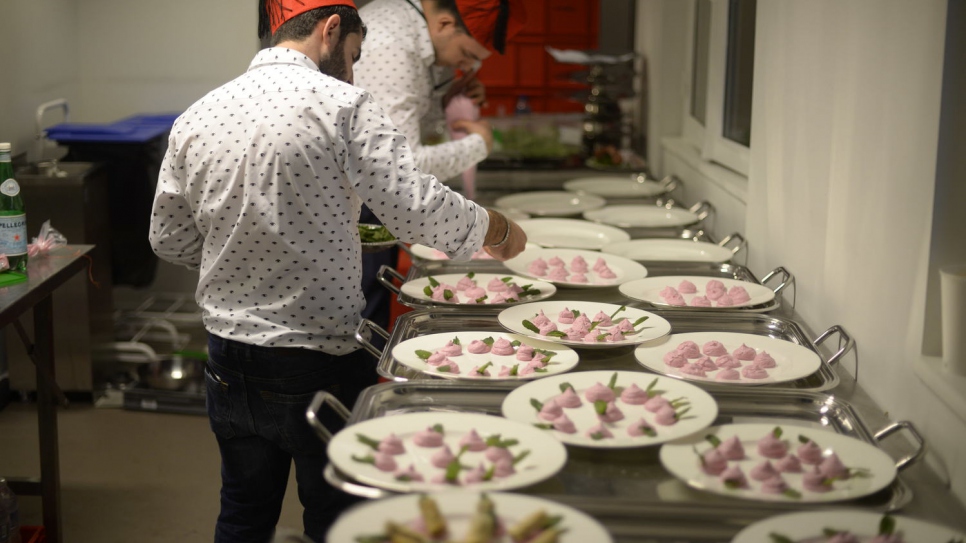 Former Syrian TV chef Mohammad El Khaldy's team prepare a menu that included Middle Eastern specialities for Kenzo's show in Paris.