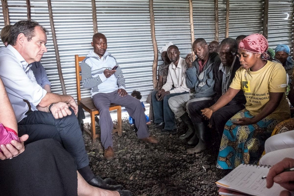 Germany's Ambassador to the DRC, Thomas Terstegen (left), speaks with formerly displaced Congolese who are now settled in Rusayo, North Kivu Province, DRC.