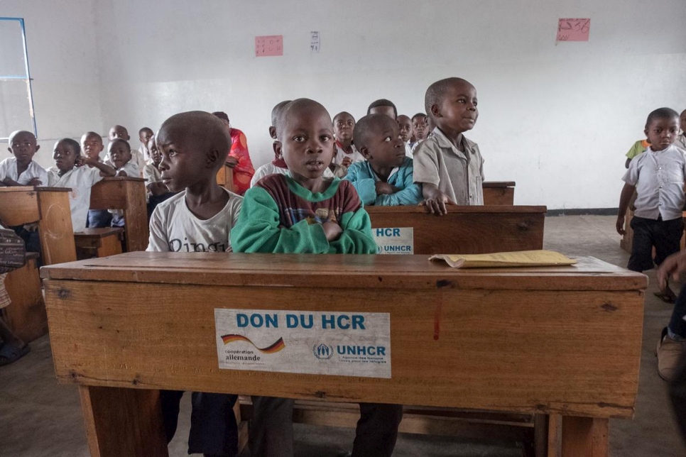 Formerly displaced children sit in a new classroom constructed and equipped by UNHCR in Rusayo, DRC.  The extension of the school has helped increase the number of students from 400 to almost 600. 