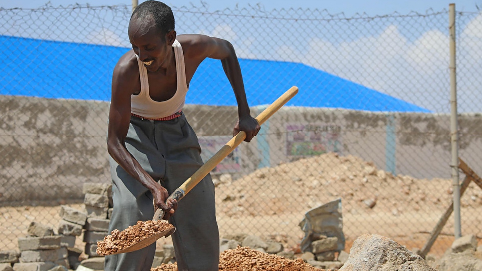 Mohamed also does part-time construction work to support his family since returning to Somalia.