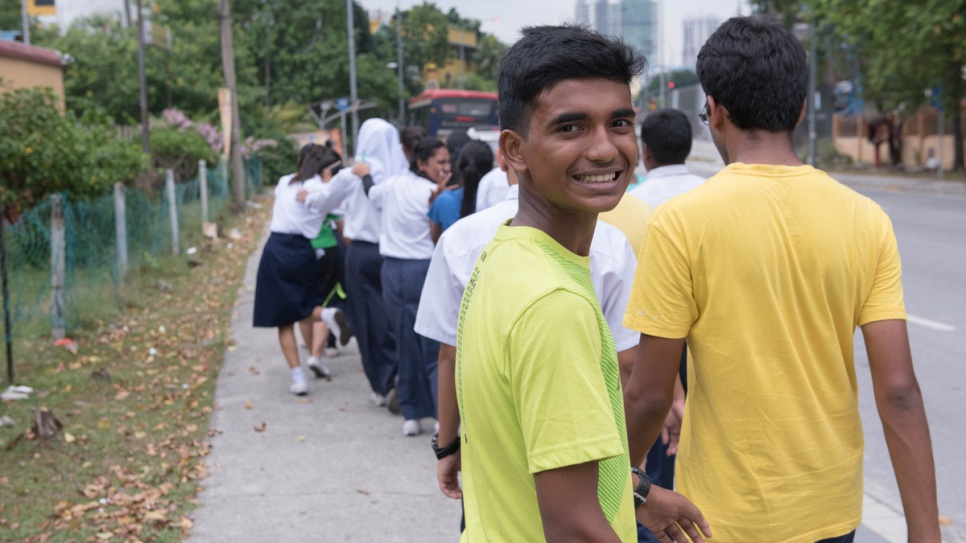 Along with his classmates, Ishak heads to a nearby field for a practical lesson in biology. He dreams of playing football for Manchester United.
