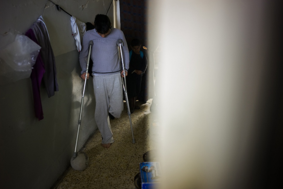 Asam plays with a football in the corridors of the temporary accommodation in Amadi, where he and his family have found refuge after fleeing attacks on Sinjar, Iraq.