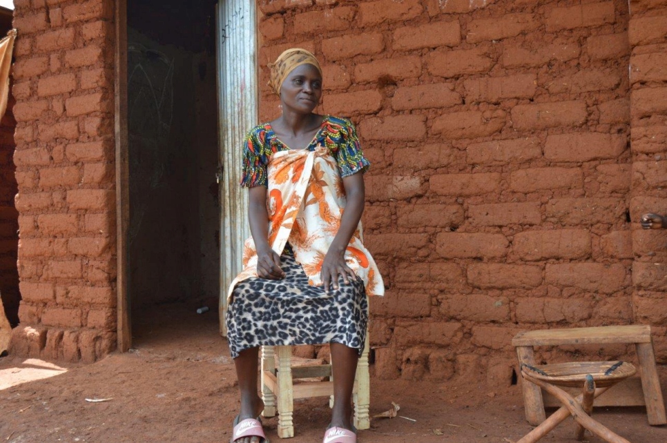 Maritha sits on a stool that she made during one of her carpentry classes.