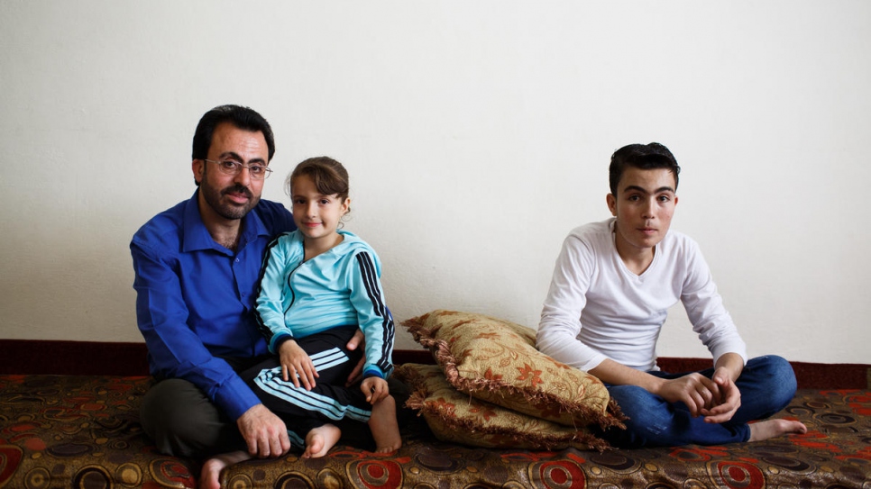 Hamed Mifleh (left) with his children Bara'a, 7, and Ahmad, 21, both of whom suffer from thalassaemia, a blood disorder that requires regular transfusions and costly medication.