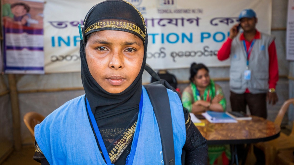 Nur Bahar, 30, a UNHCR Community Outreach Member poses for a portrait at the Information Point where she brought sisters Mabia and Shamshidah.

