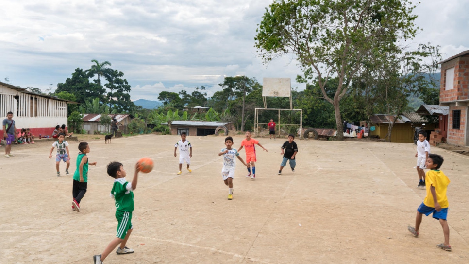 Children play football at Nueva Esperanza's school playground. The settlement's only school has 123 students enrolled in its classes.