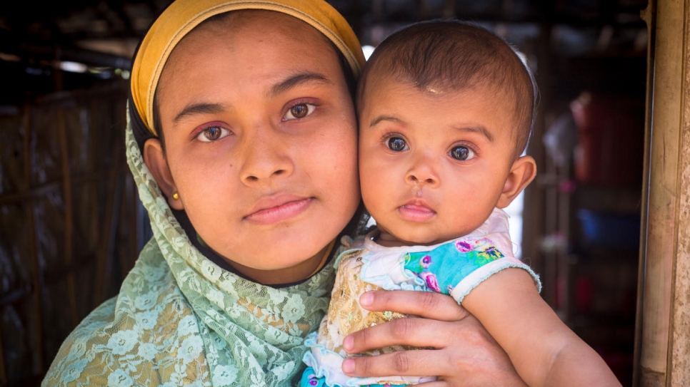 Safita Begum holding her baby daughter, Rumi.  Khaleda Begum allowed Safita and her husband Mohammed Kausar to stay on her farm after they arrived. Rumi was born days later.