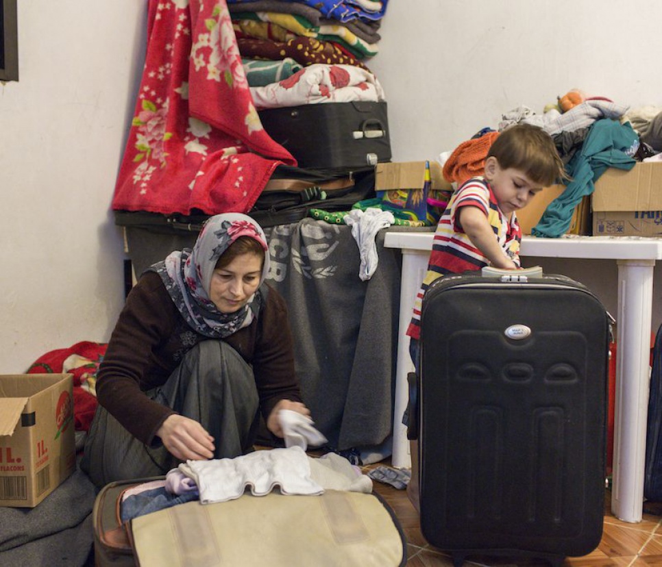 Omar helps his mother and siblings pack their belongings in preparation for their move to Finland. The family are being resettled after several years as refugees in Lebanon.