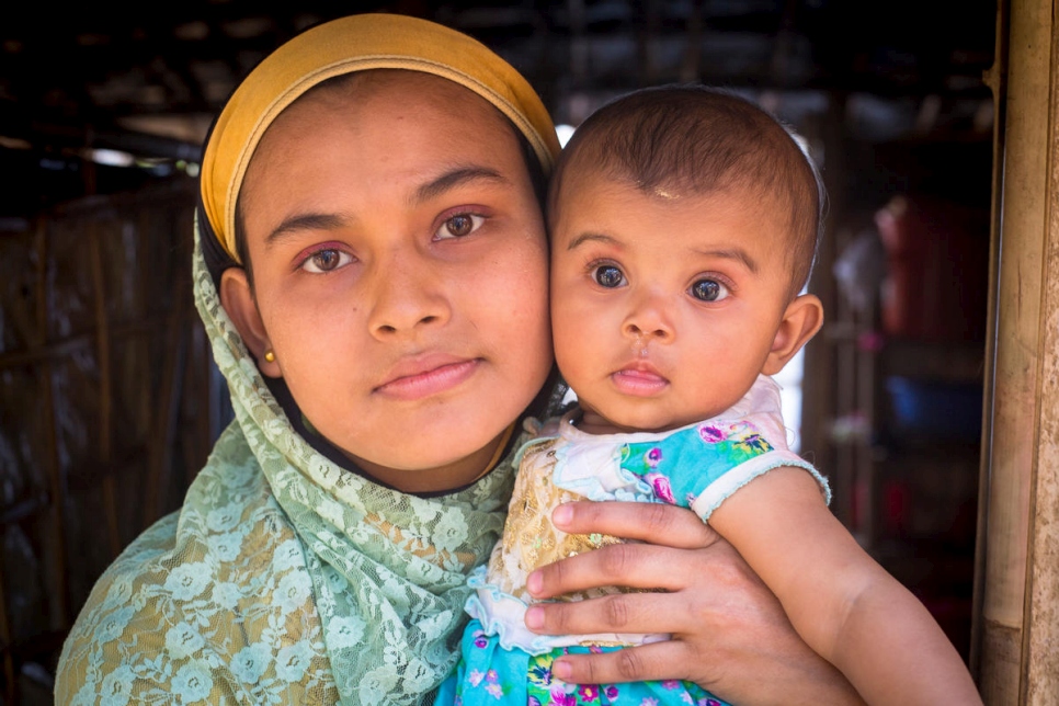 Safita Begum holding her baby daughter, Rumi.  Khaleda Begum allowed Safita and her husband Mohammed Kausar to stay on her farm after they arrived. Rumi was born days later.