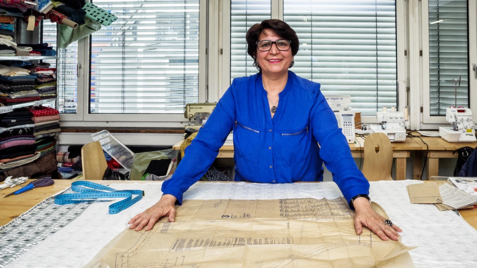 Afghan refugee Jamila measures cloth at at Social Fabric in Zürich, where she takes part in classes to design and make her own clothes.