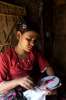 A young woman learns embroidery in Nayapara camp, Cox's Bazar district.