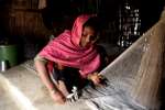 A woman weaves fishing nets to sell in the local market, Nayapara camp, Cox's Bazar.