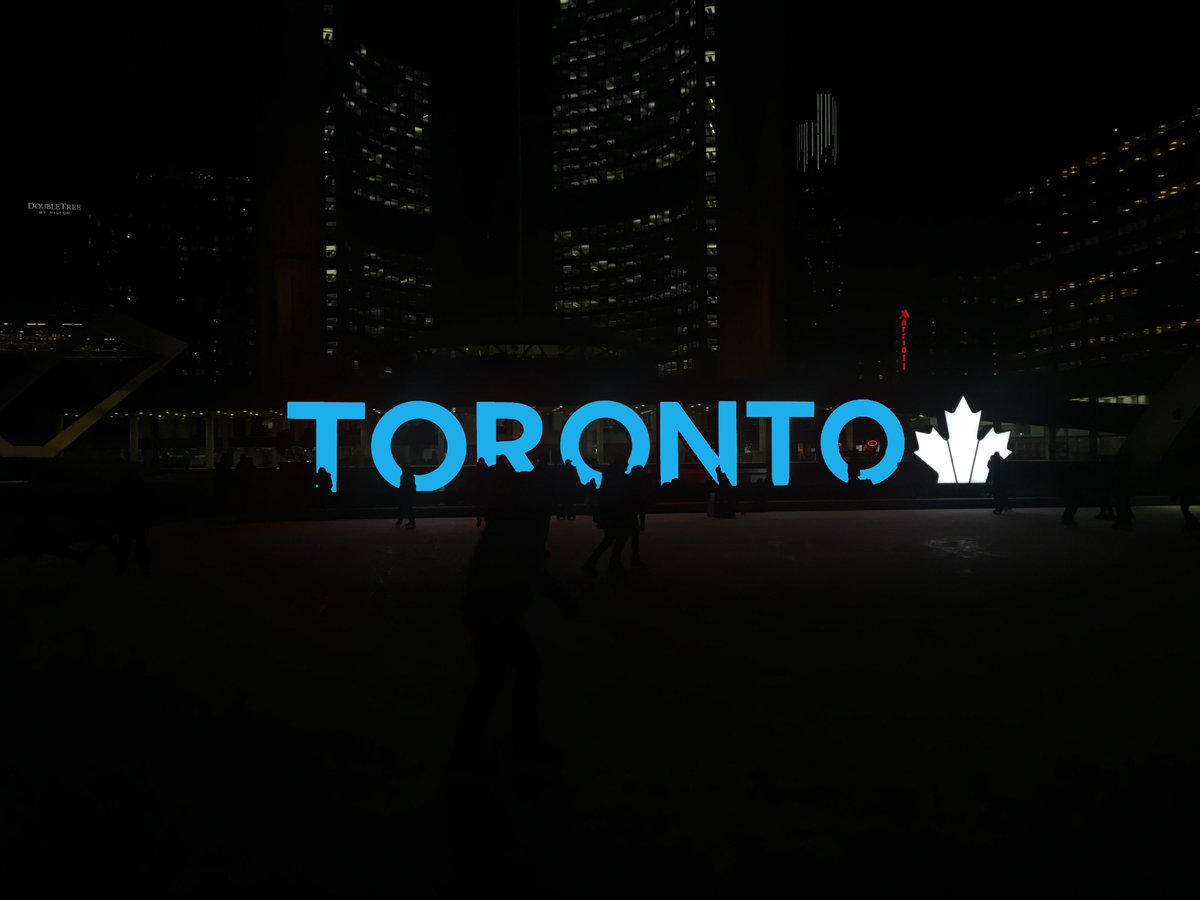 The Toronto sign in front of City Hall in downtown Toronto illuminated in blue