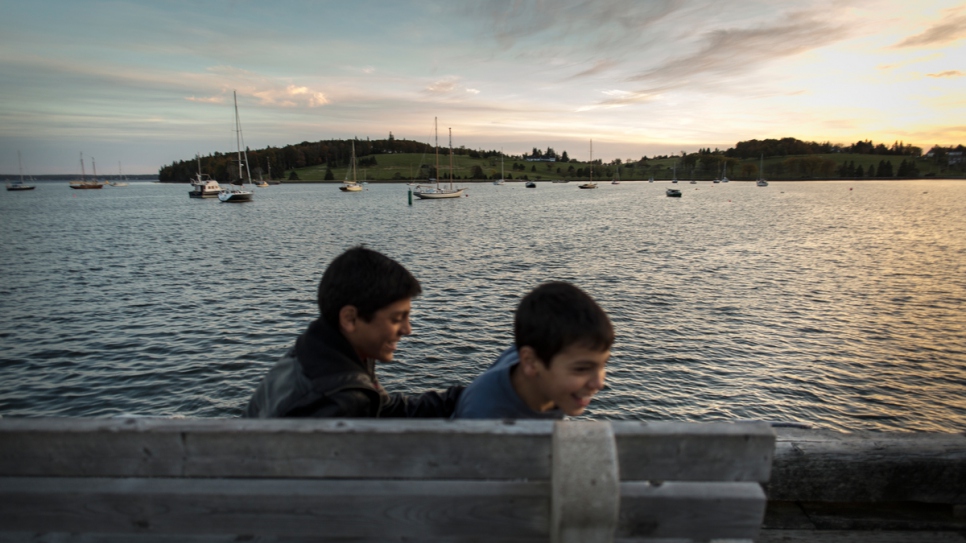 Mohammad and Zkareya Ayash play on the pier.