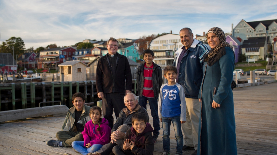 Father Michael Mitchell and David Friendly are among the private sponsors helping the Ayash family.