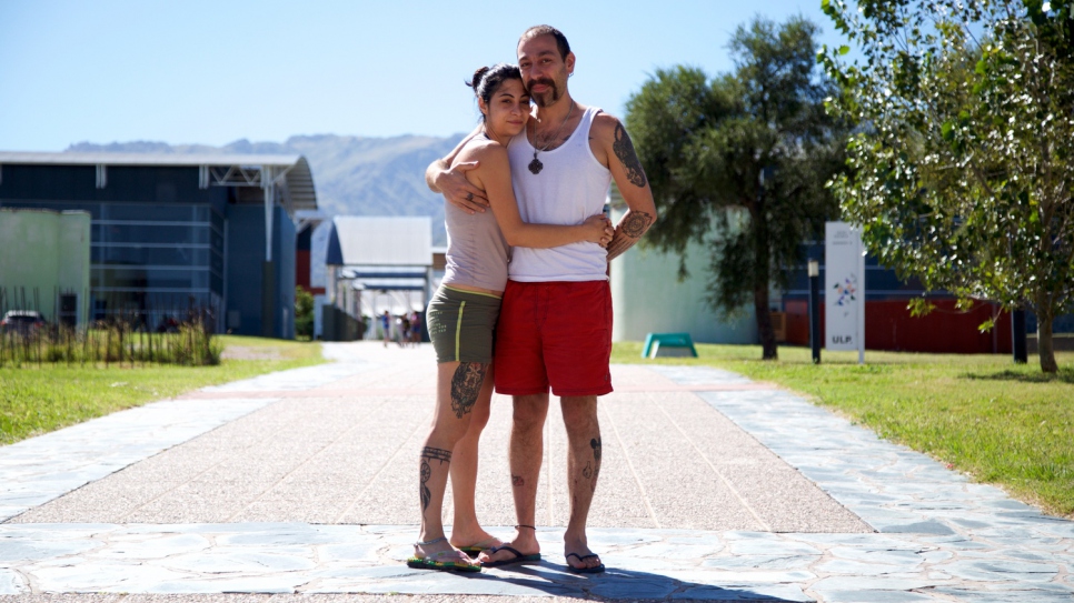 Majd and Lana embrace outside the entrance to their new apartment block.