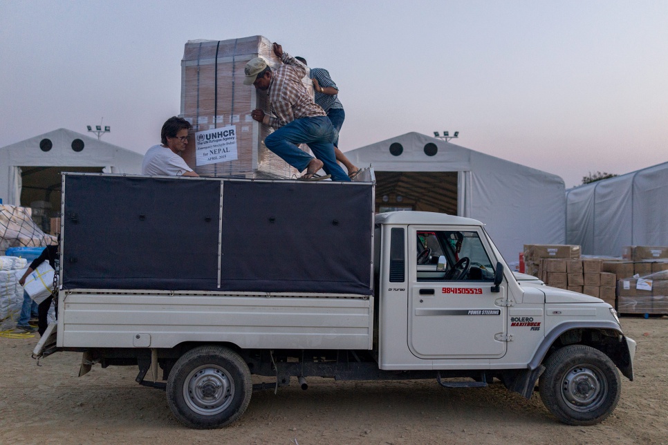 Volunteers load UNHCR relief supplies onto a truck at Tribhuvan International Airport in Kathmandu, Nepal. The aid will be distributed to affected areas across the country.