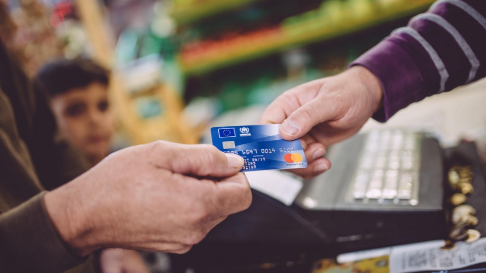 Ahmed buys groceries in the market in Chania, north-west Crete. Cash assistance allows asylum-seekers to meet basic needs while contributing to the local economy.