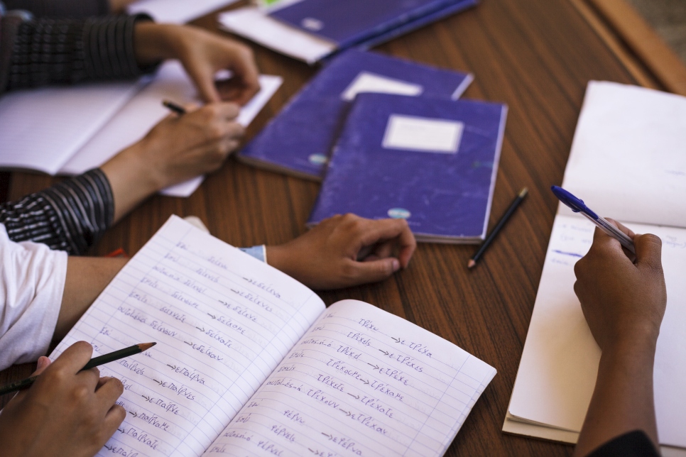 Greece. Afghan refugees learn Greek at Schistos site