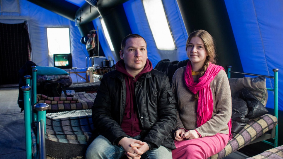 Sasha and Yulia wait in a heated tent at Mariinka checkpoint.