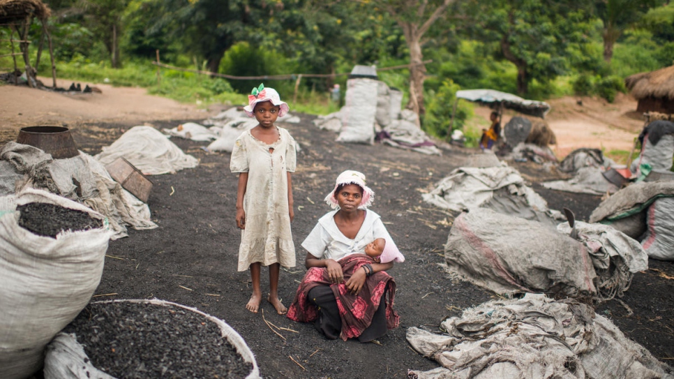 "We get 500 Congolese Francs (30 US cents) for one bag. We make three or four bags a day." Sesame, 9, and her mother Adele, 25, earn money transporting coal. Sesame's father was killed.