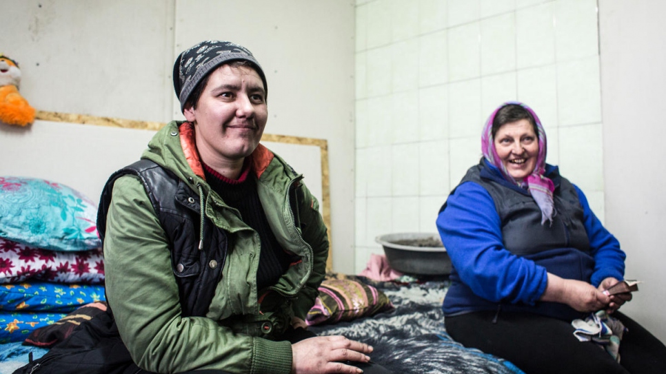 Liuba sits with her friend and neighbour Natalia.