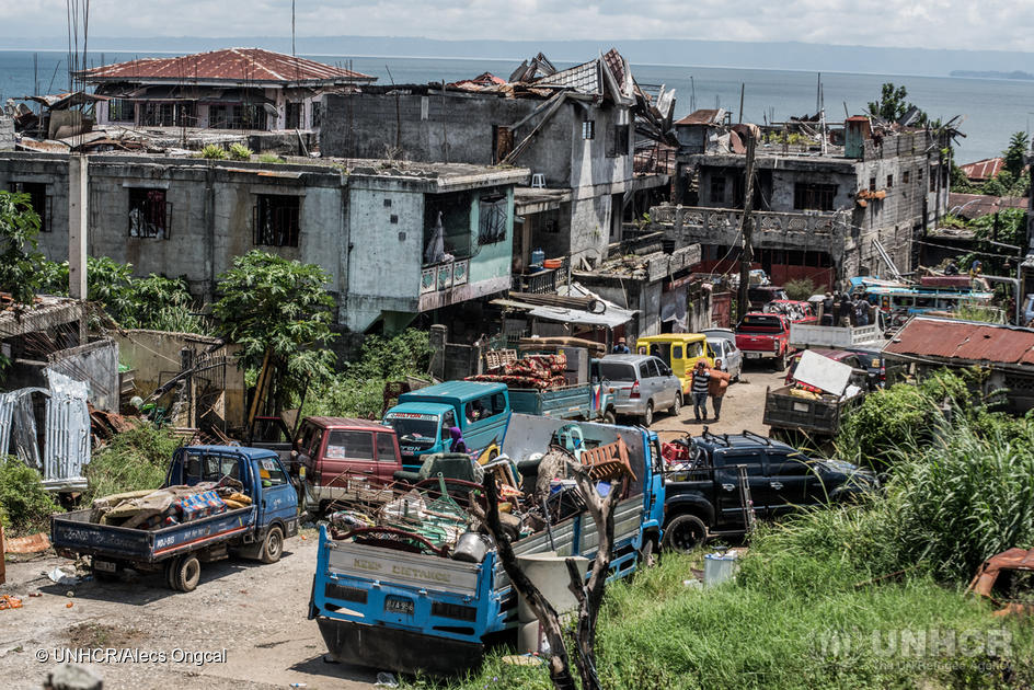 Philippines. Displaced families visit homes in war-torn city
