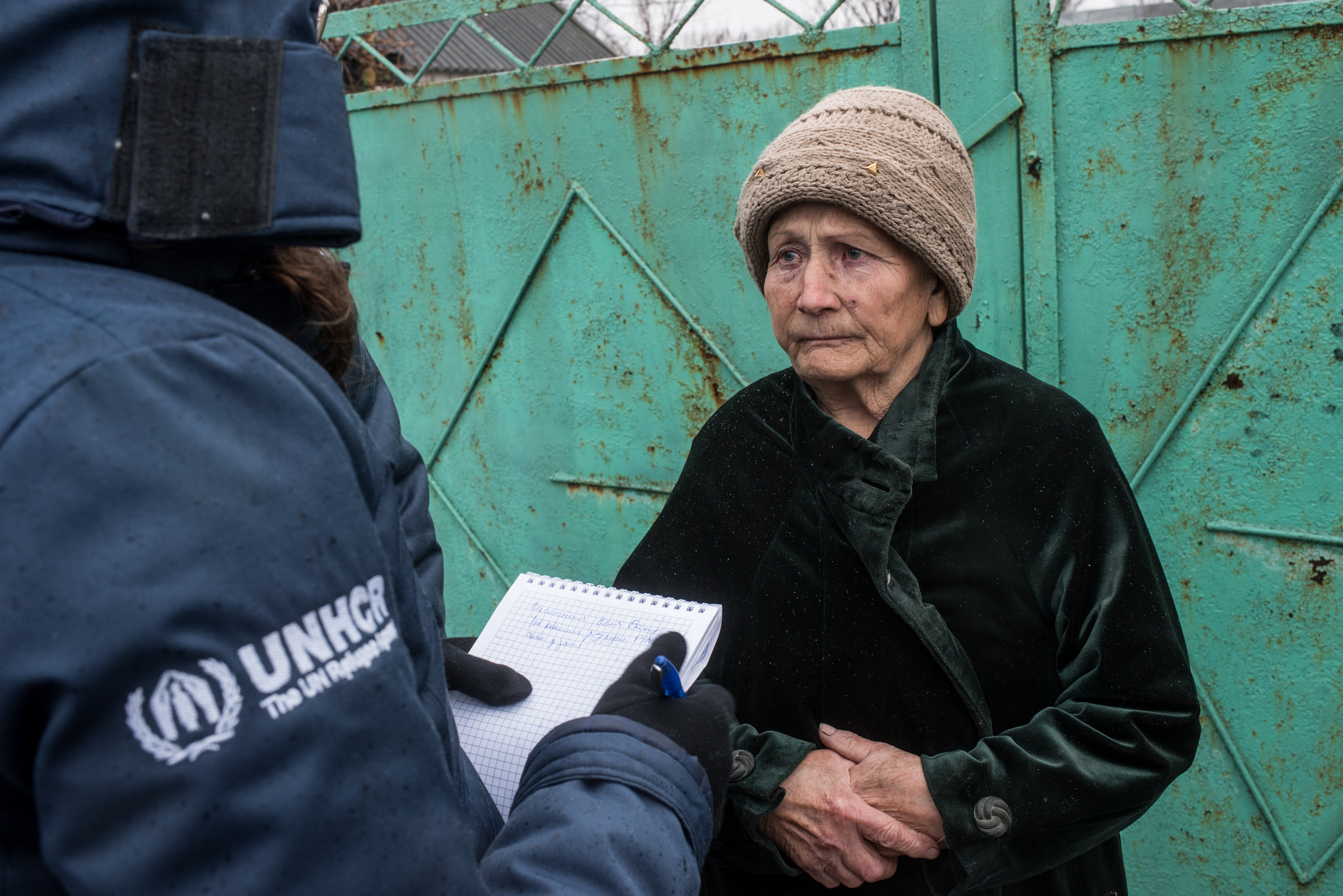 A woman speaks with UNHCR at the frontline village of Luhanske on 12 January 2017.