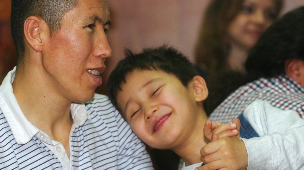 A refugee from Afghanistan's Hazara minority, who fled the violence of the Taliban to find refuge in Timisoara, enjoys a social moment with his wife and children.