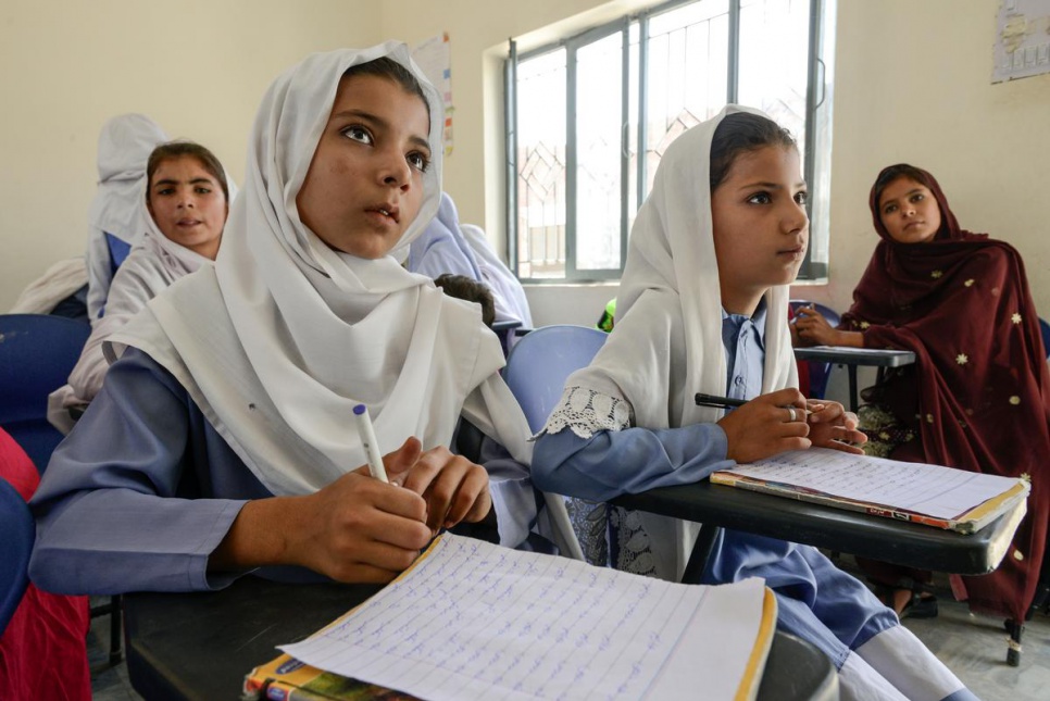 Nadia, 12, left, and Haseena, 9, study at Aqeela Asifi's girls school in Kot Chandana refugee village in Mianwali, Pakistan.