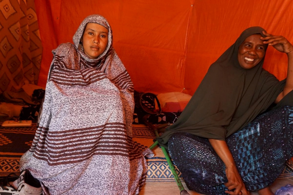Fadumo Mohamed Ali sits with her foster daughter in their home in Sheder camp, Ethiopia. They are happy about the cash assistance they have received. 