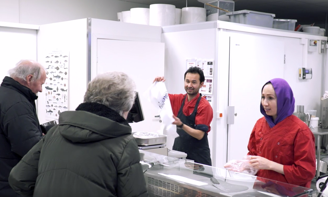 Asif and his wife Freshta behind the counter at Fiskebua. Photo: UNHCR/Max-Michel Kolijn