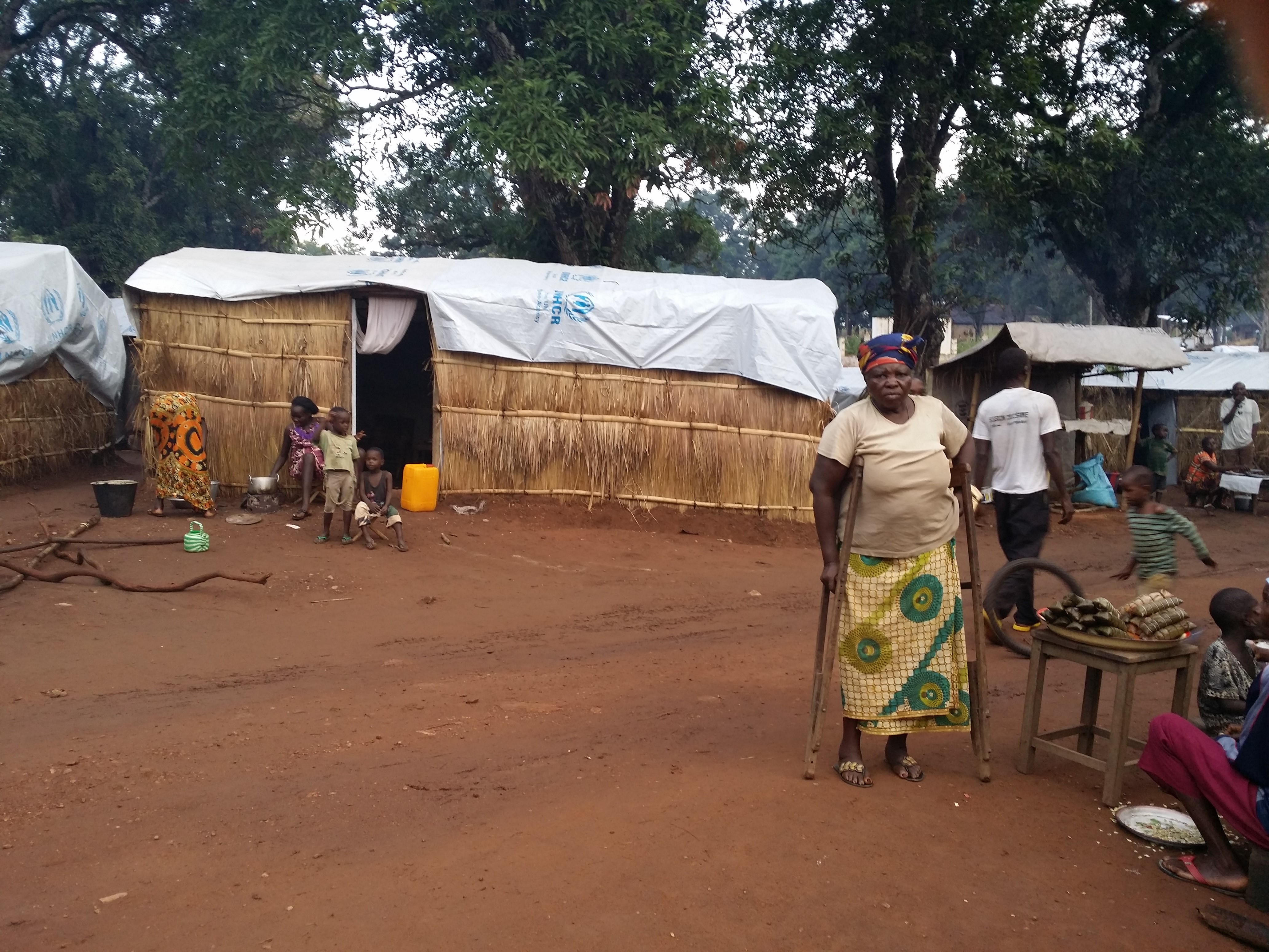 Disabled woman in front of self-constructed shelter with UNHCR provided material in IDP camp in Bambari, Central African Republic. /UNHCR/Lisa van Hogerlinden