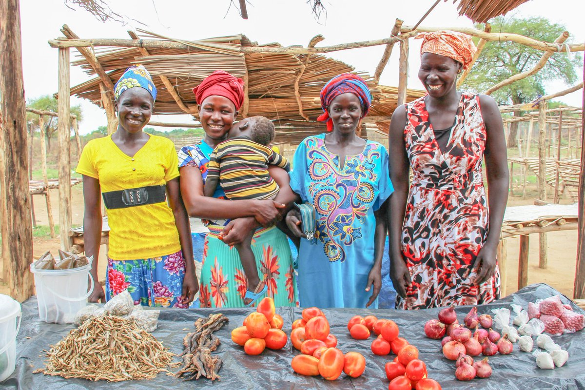 Vicky Sadia (second to left), with friends; Lona Sunday (last on the left), Poni Ana (second to right), and Joyce Ebua (last on the right) at their stall in Zone 5, Bidibidi settlement, Yumbe district. Their stall was set up through UNDP Uganda and Government of Japan programme support. (Photo credit: UNDPUganda/Natsuki 2018).