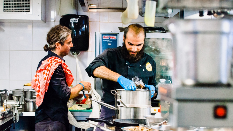 Le réfugié Mohammed (à droite), un architecte qui cuisine par plaisir, prépare plusieurs plats syriens aux côtés de Luis, le chef du restaurant De Balie à Amsterdam, lors du Refugee Food Festival. "Je ne suis pas un chef formé, mais j'aime cuisiner", déclare Mohammed. "Ma mère m'a appris tout."
