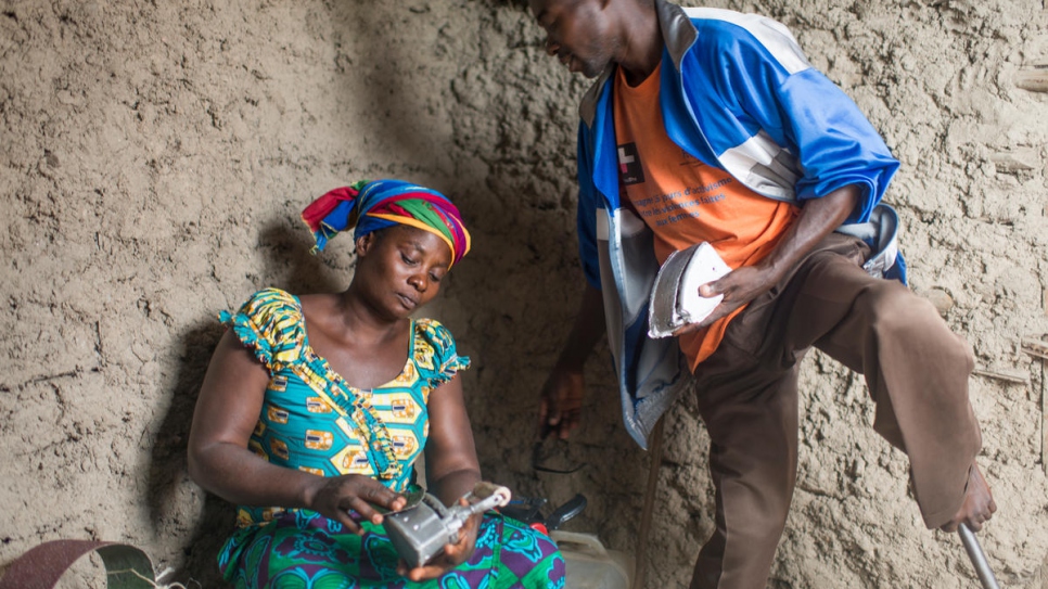 Adeline Hatangimana (left), 30, lost an eye when she was a young girl. She now works with Mathias Nzorigendera (right) to turn scrap metal into household items.