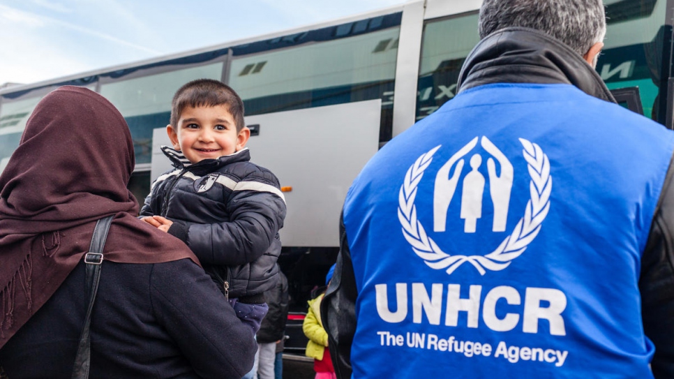 A refugee boy smiles after arrving in the port of Piraeus from the Greek island of Samos.