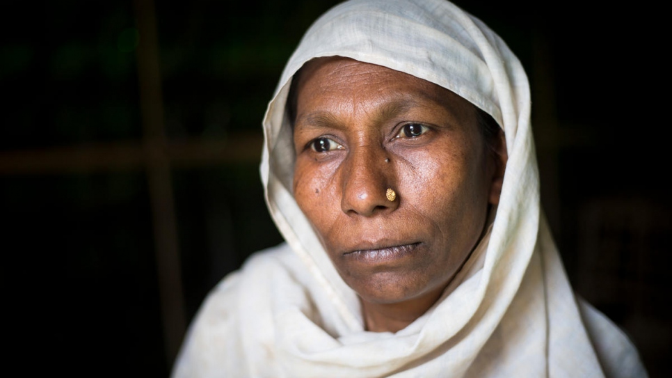 Rohingya refugee Ayesha Begum, 40, poses for a photo in the family's shelter in Bangladesh.