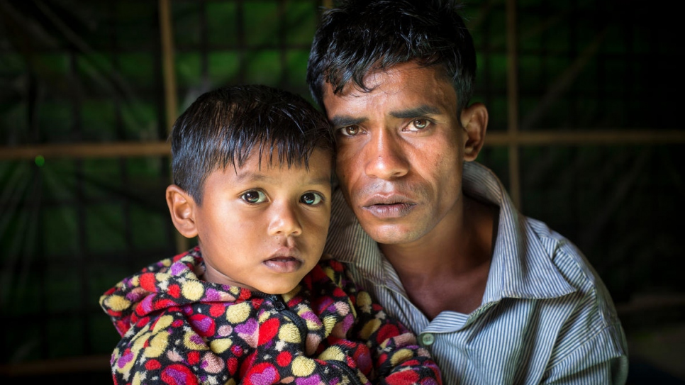 Mohammad Ayub, 31, and his daughter Kismat Ara, 3, pose for a photo in the family's one-room shelter.