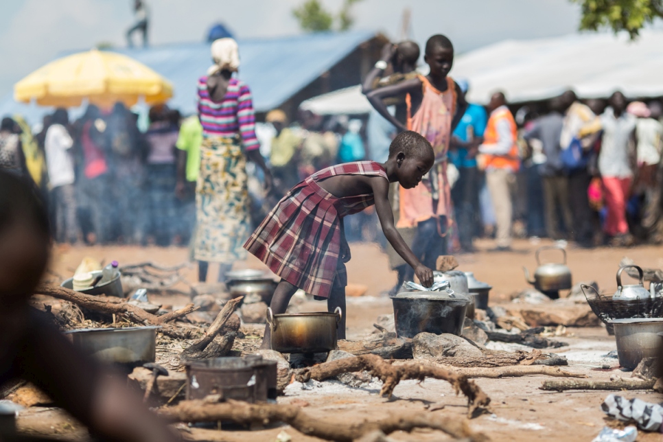 Uganda. A young South Sudanese refugee cooks food at a camp in northern Uganda